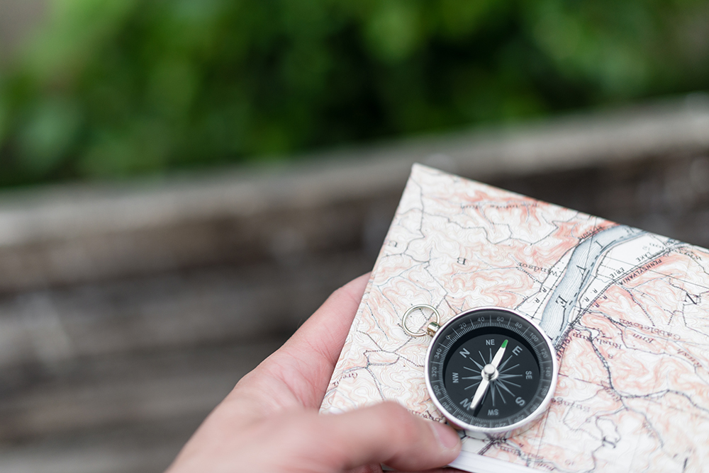 Compass and map in hand