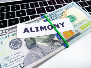 Concept of paying alimony, stack of money on the table.