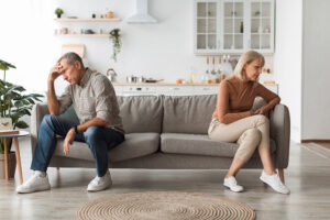 Unhappy Senior Couple Not Speaking After Quarrel Thinking About Divroce Sitting Back-To-Back, Experiencing Marital Crisis In Relationship At Home. Spouses Having Comunication Issues